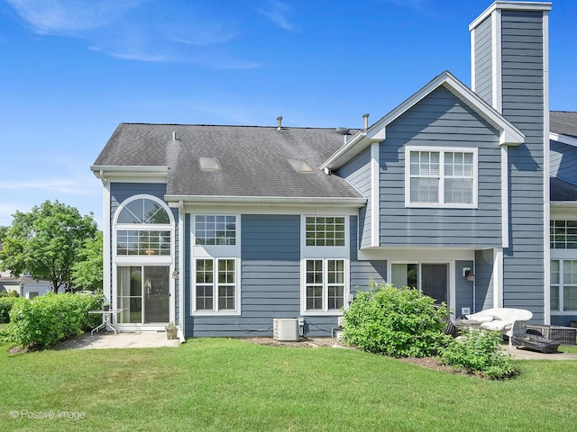 673 Kingsbridge Dr, Carol Stream, IL 60188 - back of house with a yard, a shingled roof, and a chimney