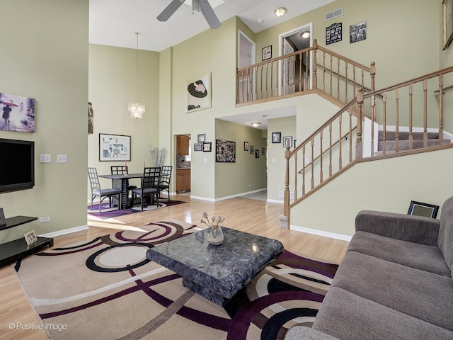 673 Kingsbridge Dr, Carol Stream, IL 60188 - living area featuring wood finished floors, a high ceiling, stairs, and ceiling fan