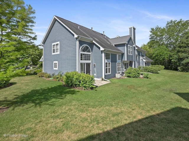 673 Kingsbridge Dr, Carol Stream, IL 60188 - view of side of property with a chimney and a yard