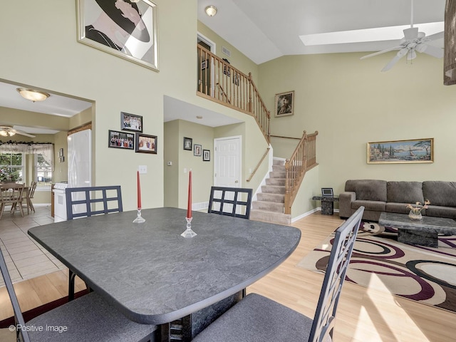 673 Kingsbridge Dr, Carol Stream, IL 60188 - dining space with a ceiling fan, stairs, wood finished floors, and high vaulted ceiling