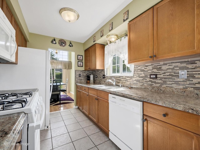 673 Kingsbridge Dr, Carol Stream, IL 60188 - kitchen featuring white appliances, healthy amount of natural light, decorative backsplash, and light tile patterned flooring