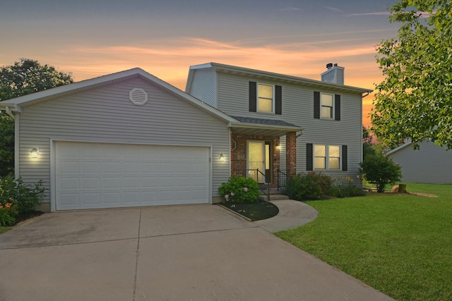 708 Wheeler Dr, Hudson, IL 61748 - traditional-style house with concrete driveway, a front yard, a chimney, a garage, and brick siding