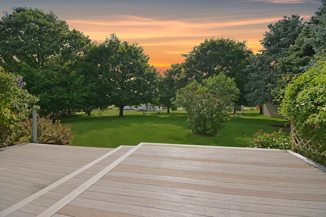 708 Wheeler Dr, Hudson, IL 61748 - deck at dusk with a lawn