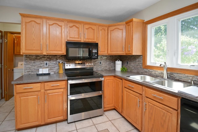 708 Wheeler Dr, Hudson, IL 61748 - kitchen with black appliances, light tile patterned flooring, decorative backsplash, and dark countertops