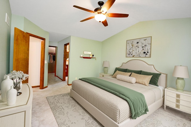 708 Wheeler Dr, Hudson, IL 61748 - bedroom featuring light carpet, vaulted ceiling, a spacious closet, a ceiling fan, and a closet
