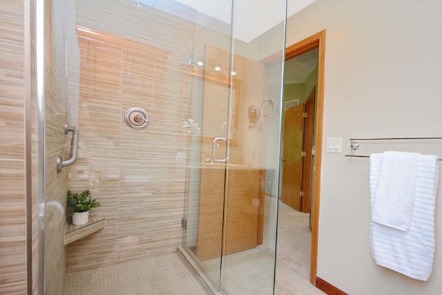 708 Wheeler Dr, Hudson, IL 61748 - bathroom featuring a shower stall and tile patterned flooring