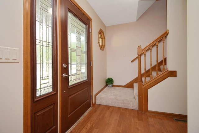 708 Wheeler Dr, Hudson, IL 61748 - foyer with light wood finished floors and stairs