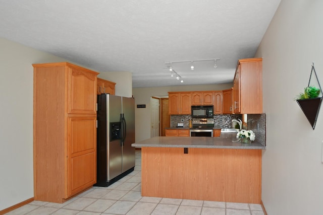 708 Wheeler Dr, Hudson, IL 61748 - kitchen with appliances with stainless steel finishes, a peninsula, backsplash, light tile patterned flooring, and a breakfast bar area