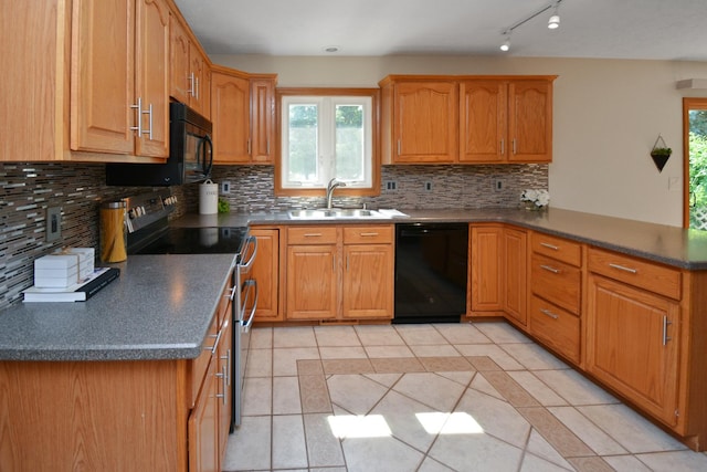 708 Wheeler Dr, Hudson, IL 61748 - kitchen with black appliances, a peninsula, light tile patterned floors, decorative backsplash, and dark countertops