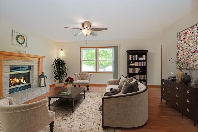 708 Wheeler Dr, Hudson, IL 61748 - living area with ceiling fan, wood finished floors, and a brick fireplace