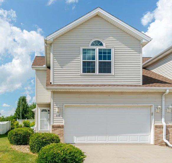 516 Wild Turkey Ln, Normal, IL 61761 - view of front of property featuring brick siding, concrete driveway, and a garage