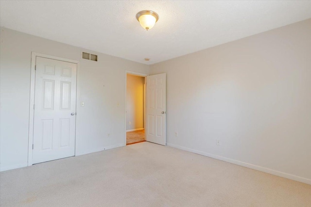 516 Wild Turkey Ln, Normal, IL 61761 - unfurnished bedroom with light colored carpet and baseboards