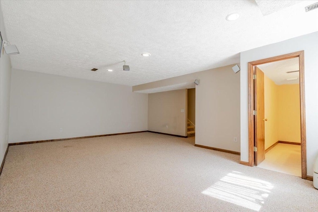 516 Wild Turkey Ln, Normal, IL 61761 - finished basement with a textured ceiling, stairway, light carpet, and recessed lighting