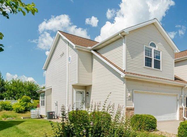 516 Wild Turkey Ln, Normal, IL 61761 - view of property exterior featuring a garage, driveway, and a lawn