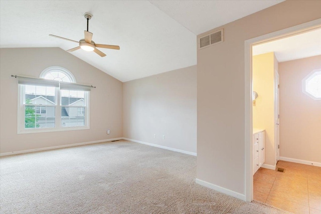 516 Wild Turkey Ln, Normal, IL 61761 - empty room featuring a ceiling fan, vaulted ceiling, and light colored carpet