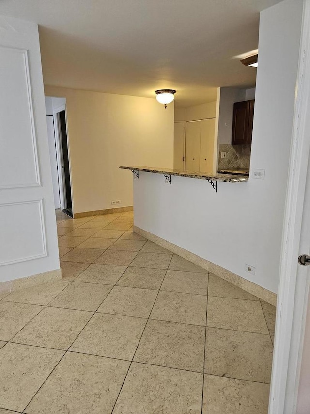 222 E Pearson St Unit 1801, Chicago, IL 60611 - spare room featuring baseboards and light tile patterned floors