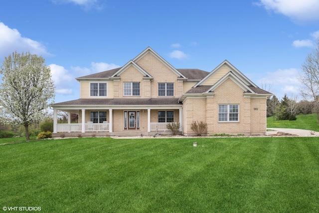 7271 Orchard Valley Dr, Bull Valley, IL 60050 - view of front of home featuring brick siding, covered porch, a front yard, and a shingled roof
