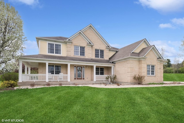 7271 Orchard Valley Dr, Bull Valley, IL 60050 - view of front facade with brick siding, covered porch, a front yard, and roof with shingles