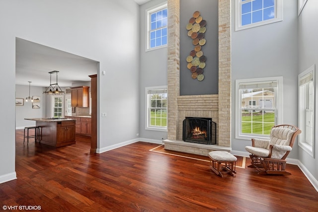 7271 Orchard Valley Dr, Bull Valley, IL 60050 - living area with a high ceiling, dark wood-style flooring, and a fireplace