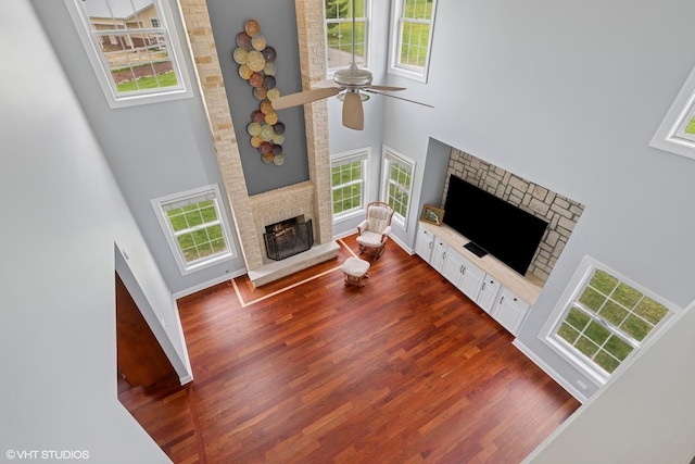 7271 Orchard Valley Dr, Bull Valley, IL 60050 - living area with a fireplace, a high ceiling, dark wood-type flooring, healthy amount of natural light, and ceiling fan