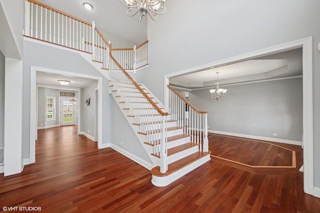 7271 Orchard Valley Dr, Bull Valley, IL 60050 - stairs with a chandelier, wood finished floors, and a towering ceiling