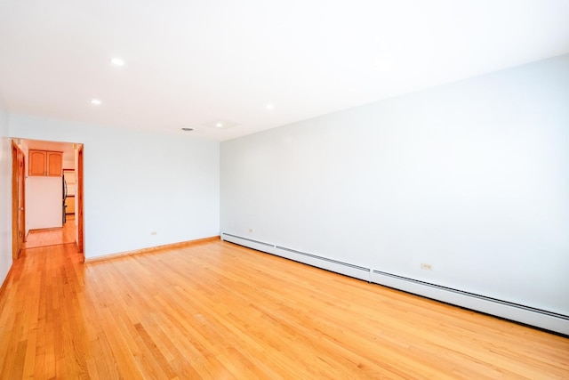 2418 S 58th Ave, Cicero, IL 60804 - empty room featuring a baseboard heating unit, light wood-type flooring, and recessed lighting