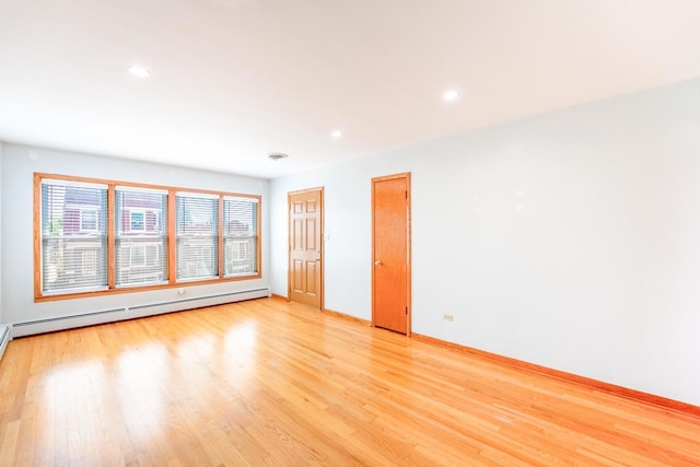 2418 S 58th Ave, Cicero, IL 60804 - empty room featuring baseboard heating, light wood finished floors, and recessed lighting
