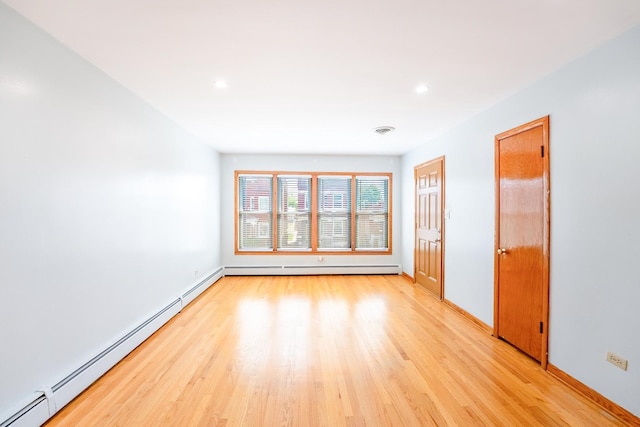 2418 S 58th Ave, Cicero, IL 60804 - unfurnished room with baseboard heating, light wood-style floors, and recessed lighting