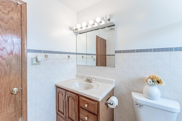 2418 S 58th Ave, Cicero, IL 60804 - bathroom with vanity, tile walls, and wainscoting