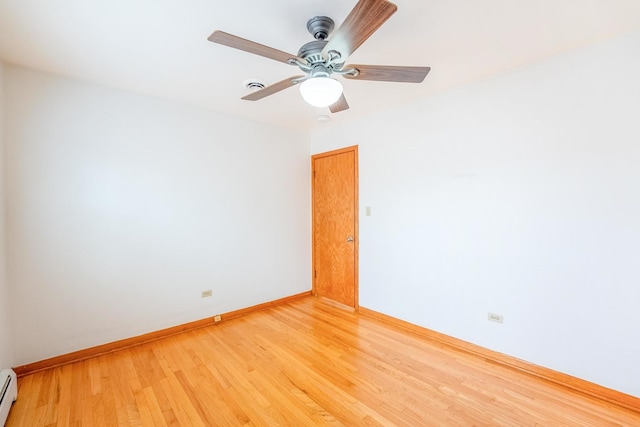 2418 S 58th Ave, Cicero, IL 60804 - spare room featuring baseboard heating, light wood-style flooring, and a ceiling fan