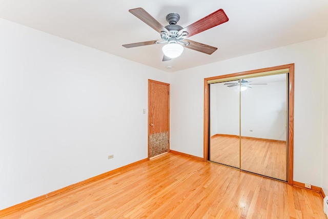 2418 S 58th Ave, Cicero, IL 60804 - unfurnished bedroom featuring light wood-style floors, a closet, and ceiling fan