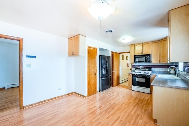 2418 S 58th Ave, Cicero, IL 60804 - kitchen with black appliances, a baseboard radiator, light brown cabinets, and light wood finished floors