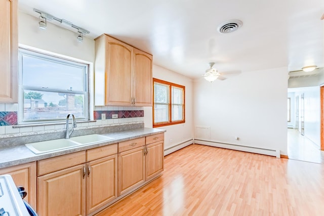 2418 S 58th Ave, Cicero, IL 60804 - kitchen featuring light brown cabinets, tasteful backsplash, plenty of natural light, and light wood-style flooring