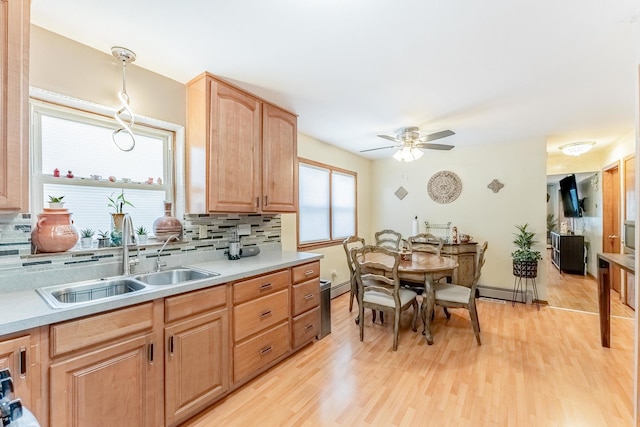 2418 S 58th Ave, Cicero, IL 60804 - kitchen with backsplash, light wood-style floors, light countertops, and ceiling fan