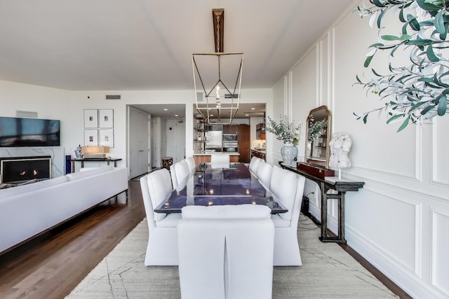 401 N Wabash Ave Unit 35J, Chicago, IL 60611 - dining area featuring light wood finished floors and a premium fireplace
