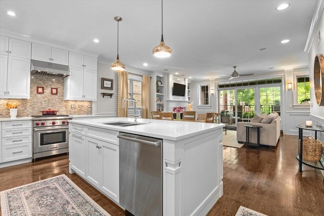 657 W Melrose St Unit 2, Chicago, IL 60657 - kitchen featuring stainless steel appliances, under cabinet range hood, open floor plan, light countertops, and decorative backsplash