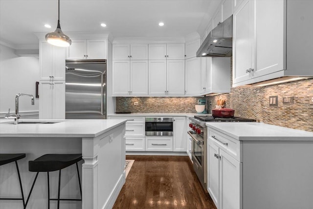 657 W Melrose St Unit 2, Chicago, IL 60657 - kitchen featuring high end appliances, ventilation hood, a kitchen bar, dark wood-type flooring, and light countertops