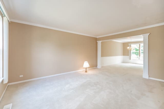 24625 Woodstock Dr, Plainfield, IL 60585 - spare room with decorative columns, a chandelier, light carpet, and crown molding