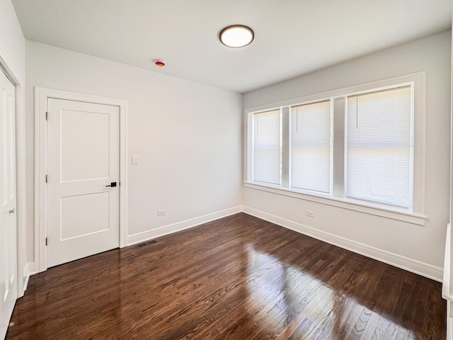 7755 S Wolcott Ave, Chicago, IL 60620 - unfurnished room featuring dark wood finished floors and baseboards