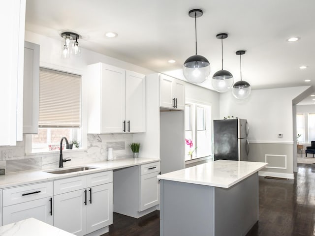 7755 S Wolcott Ave, Chicago, IL 60620 - kitchen featuring freestanding refrigerator, backsplash, white cabinets, dark wood-type flooring, and recessed lighting