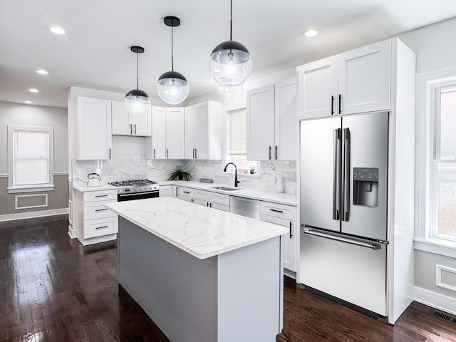 7755 S Wolcott Ave, Chicago, IL 60620 - kitchen featuring appliances with stainless steel finishes, tasteful backsplash, dark wood-style floors, white cabinetry, and recessed lighting