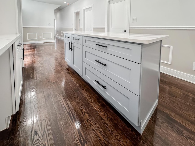 7755 S Wolcott Ave, Chicago, IL 60620 - kitchen with dark wood finished floors, white cabinets, light stone countertops, and a center island