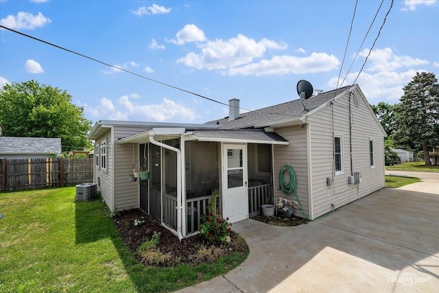 120 Riverside Dr, Montgomery, IL 60538 - back of house featuring a sunroom, a chimney, and roof with shingles