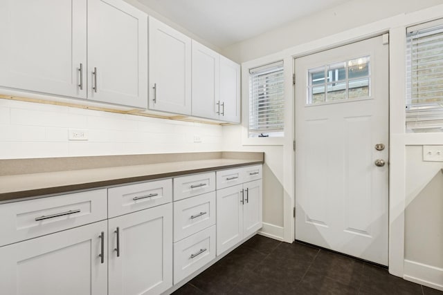 9007 Forestview Rd, Evanston, IL 60203 - kitchen with white cabinets and dark tile patterned flooring