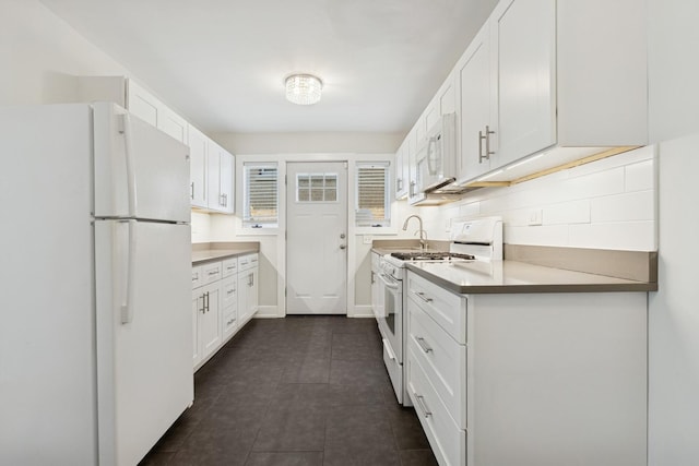 9007 Forestview Rd, Evanston, IL 60203 - kitchen with white appliances, white cabinetry, and dark tile patterned floors