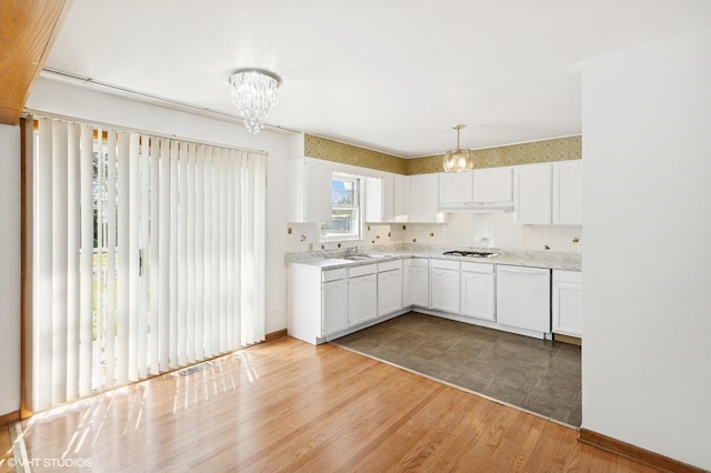 901 S Can Dota Ave, Mount Prospect, IL 60056 - kitchen featuring a chandelier, under cabinet range hood, and white cabinetry