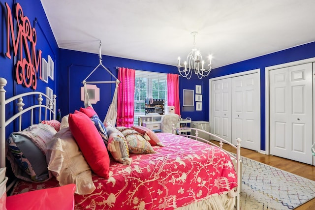 51 Mitchell Cir, Wheaton, IL 60189 - bedroom featuring a chandelier, wood finished floors, and multiple closets