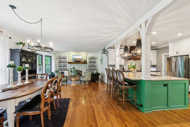 51 Mitchell Cir, Wheaton, IL 60189 - dining space with a chandelier, a fireplace, and wood finished floors