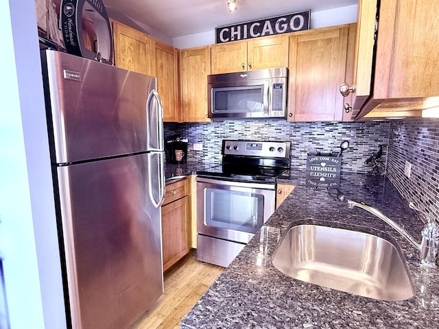 3660 N Lake Shore Dr Unit 1309, Chicago, IL 60613 - kitchen featuring appliances with stainless steel finishes, dark stone counters, light wood finished floors, tasteful backsplash, and light brown cabinets