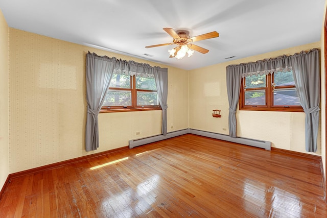 13007 S Oak Park Ave, Palos Heights, IL 60463 - empty room featuring wood-type flooring, ceiling fan, and a baseboard heating unit